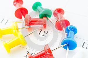 Many color pin push on calendar page.