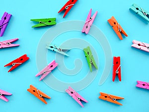 many colored clothespins on a blue background, as a substrate, pin clothes peg