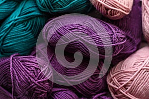 Many colored knitting wool balls background. Pattern