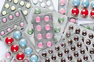 Many colored medicinal tablets, tablets and capsules. Antiviral capsules, tablets in a plastic blister pack