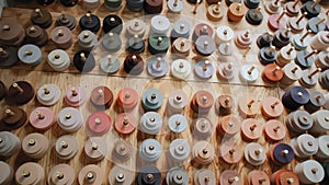 Many colored spools for overlock carpets in a store warehouse. Carpet rolls stacked at store. Move camera