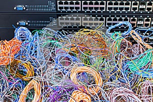 Many colored wires are in the background of network switches