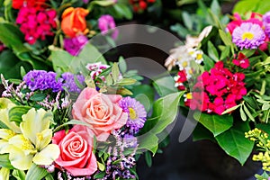 Many colorful array of fresh flower bouquets on display at an outdoor street city market on warm spring sunny day