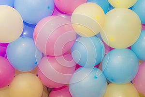 Many colorful balloons decorated wall as background.