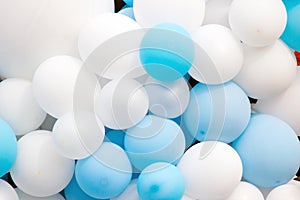 Many colorful balloons decorated wall background, blue and white balloons background