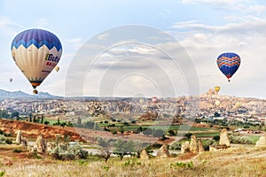 Many colorful balloons take off into the sky at dawn. All the sky in big beautiful balloons. Fabulous landscapes of the mountains