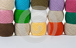 Many colorful balls of wool and cotton yarn for knitting. White isolated background. Place for text