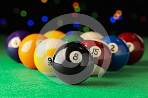 Many colorful billiard balls on green table, closeup