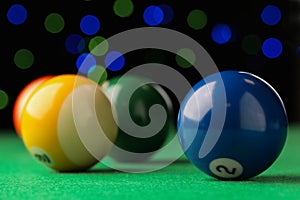 Many colorful billiard balls on green table, closeup