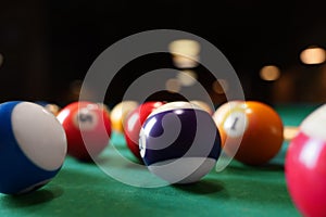 Many colorful billiard balls on green table, closeup