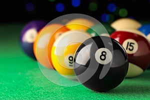 Many colorful billiard balls on green table, closeup. Space for text