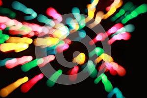 Many colorful blurred bokeh patterns on black