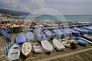 many colorful boats on the shore across the seaside view in Lavagna, Liguria, Italy. Coast view