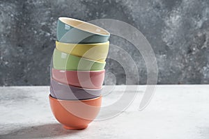 Many of colorful bowls on a gray background