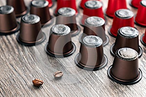 Many colorful capsules for a coffee machine lie on a beautiful wooden table