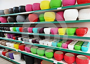 Many colorful ceramic and plastic flower pots at shop