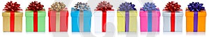 Many colorful christmas presents birthday gifts in a row panorama isolated on a white background