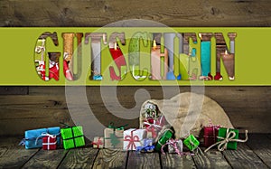 Many colorful christmas presents on wooden old background.