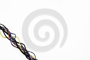 Many colorful electrical cord cables twist together into single frame line on white background. Top view, copy space