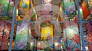 Many colorful fabric hanging lanterns.