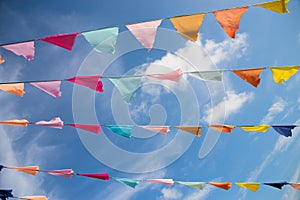 Many colorful flags against blue sky