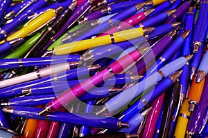 Many colorful, glossy ballpoint pens