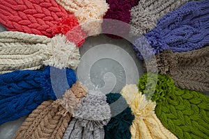 Many colorful hats lie on gray concrete background
