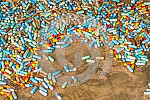 Many colorful medicines expire on cement floor