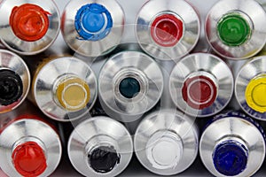 Many colorful paint tubes closeup photo