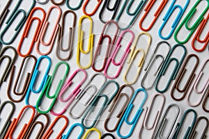Many colorful paper clips on a home office desk for stationary design as colorful pattern to tidy desk, papers and paperwork