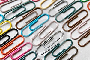 Many colorful paper clips on a home office desk for stationary design as colorful pattern to tidy desk, papers and paperwork