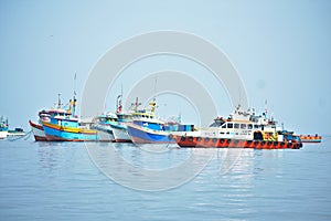 Many Colorful pastel fishing boats floating in the ocean in Paracas Peru