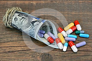 Many Colorful Pills And Capsules Dropped From Money Roll