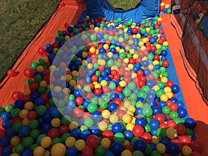 Many colorful plastic balls in a kids` ball. Stock photo