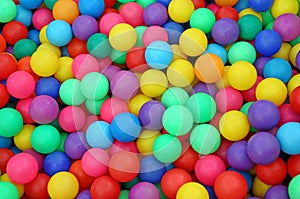 Many colorful plastic balls in a kids` ballpit