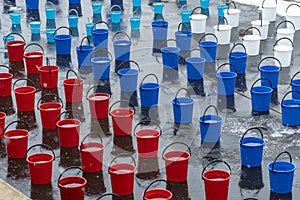 Many colorful plastic buckets. water for dousing a person, a procedure for hardening the body