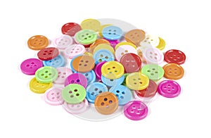 Many colorful plastic sewing buttons isolated on white