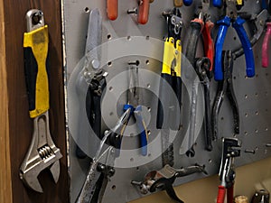 Many colorful tools on the stand in the workshop