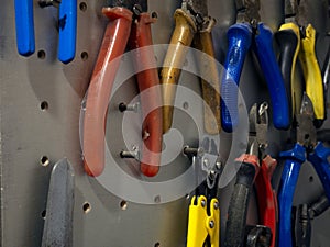 Many colorful tools on the stand in the workshop