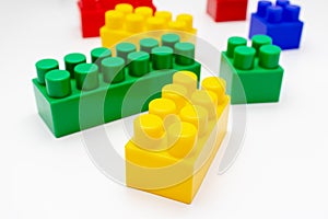 Many colorful toy plastic bricks, kit of blocks for building and constructing on white background, Children`s game and playing