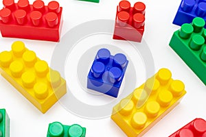 Many colorful toy plastic bricks, kit of blocks for building and constructing on white background, Children`s game and playing