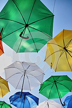 Many colorful umbrellas decorate the street