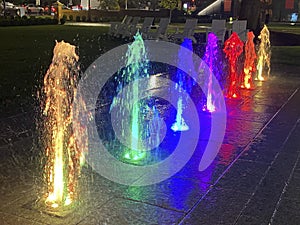 Many Colorful Water Fountain Jets at Night