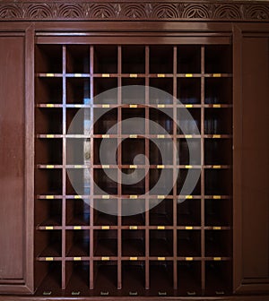 Many compartments in the wooden rack to store shoes.