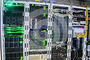 Many computer equipment is installed in the server room of the data center. Racks with servers and routers are located in the main