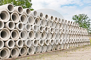 Many concrete sewer pipes piled at factory