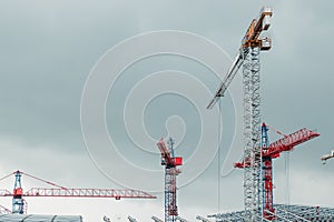 Many construction cranes on blue sky - construction site