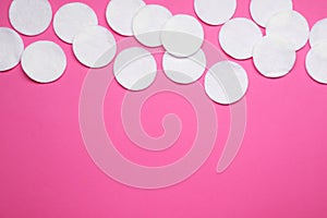 Many cotton pads on pink background, flat lay. Space for text
