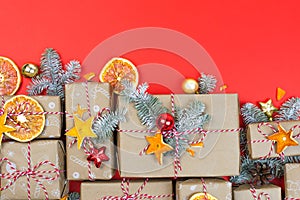 Many craft gift boxes on red background. Christmas holiday package banner template. New year zero waste still life