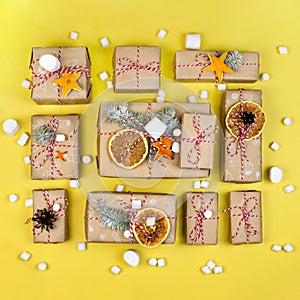 Many craft gift boxes on yellow background. Christmas holiday package above. New year knolling flat lay still lfe